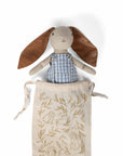 Rabbit plush doll in blue striped overalls with brown ears, in a leaf-print tote