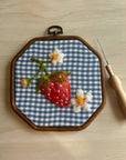Wool felting embroidery hoop with blue gingham panel, felt strawberry and flowers, needle tool