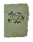 Christmas card with black “Merry Christmas” wreath design on green textured paper