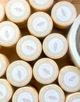 Round lip butter balm tins with gold rims, labeled vanilla bean and hydrating