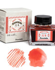 Japanese ink bottle with box and red ink color swatches on paper