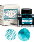 Japanese ink set with box, square bottle, and teal-blue ink swatches