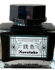 Kuretake Kuroganeiro Teal ink bottle with front label in dark blue-green
