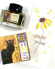 Chrome Yellow Art Nouveau ink bottle with label, plus ink splash and swatch card
