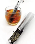 Perforated stainless steel tea infuser resting over glass cup of tea