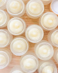 Round tallow lip butter balm tins with pale cream balm in open cups