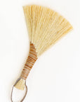 Wing broom with brown leather cord and light tan tampico bristles