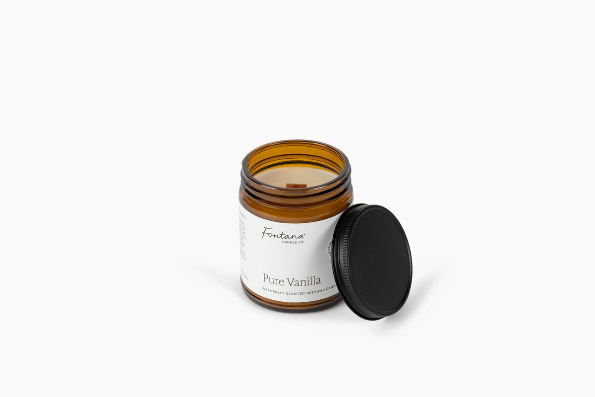 Amber jar candle with black lid beside it, Pure Vanilla label, Fontana Candle Co.