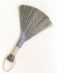 Handheld wing broom with gray fiber head, light blue wrapped handle, and white cord loop