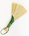 Wing broom with green wrapped handle and brown cord loop