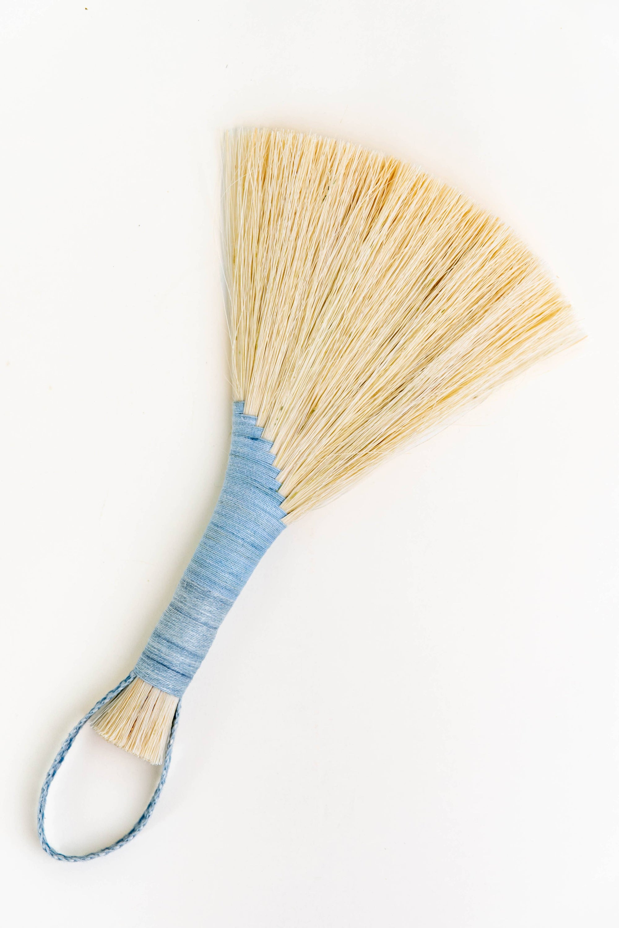 Wing broom with light blue wrapped handle and brown cord loop