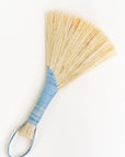 Wing broom with light blue wrapped handle and brown cord loop