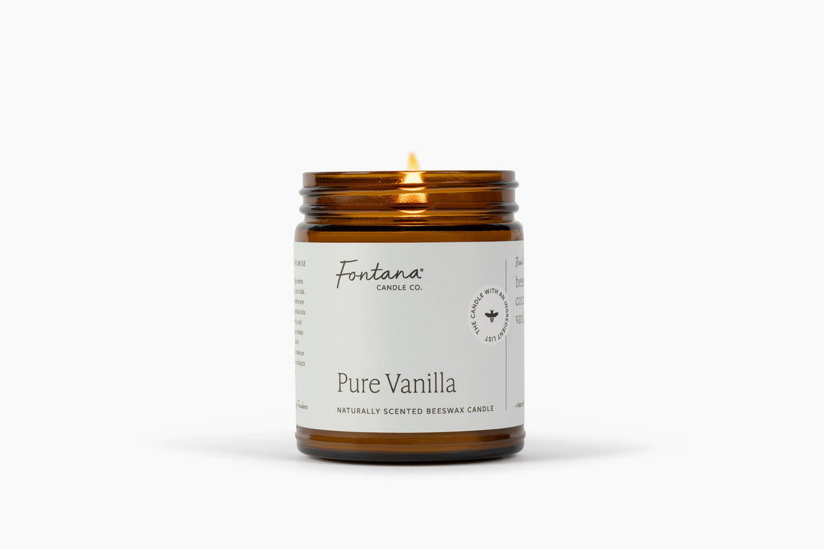 Amber jar candle with lit wick, Pure Vanilla label on jar, Fontana Candle Co.