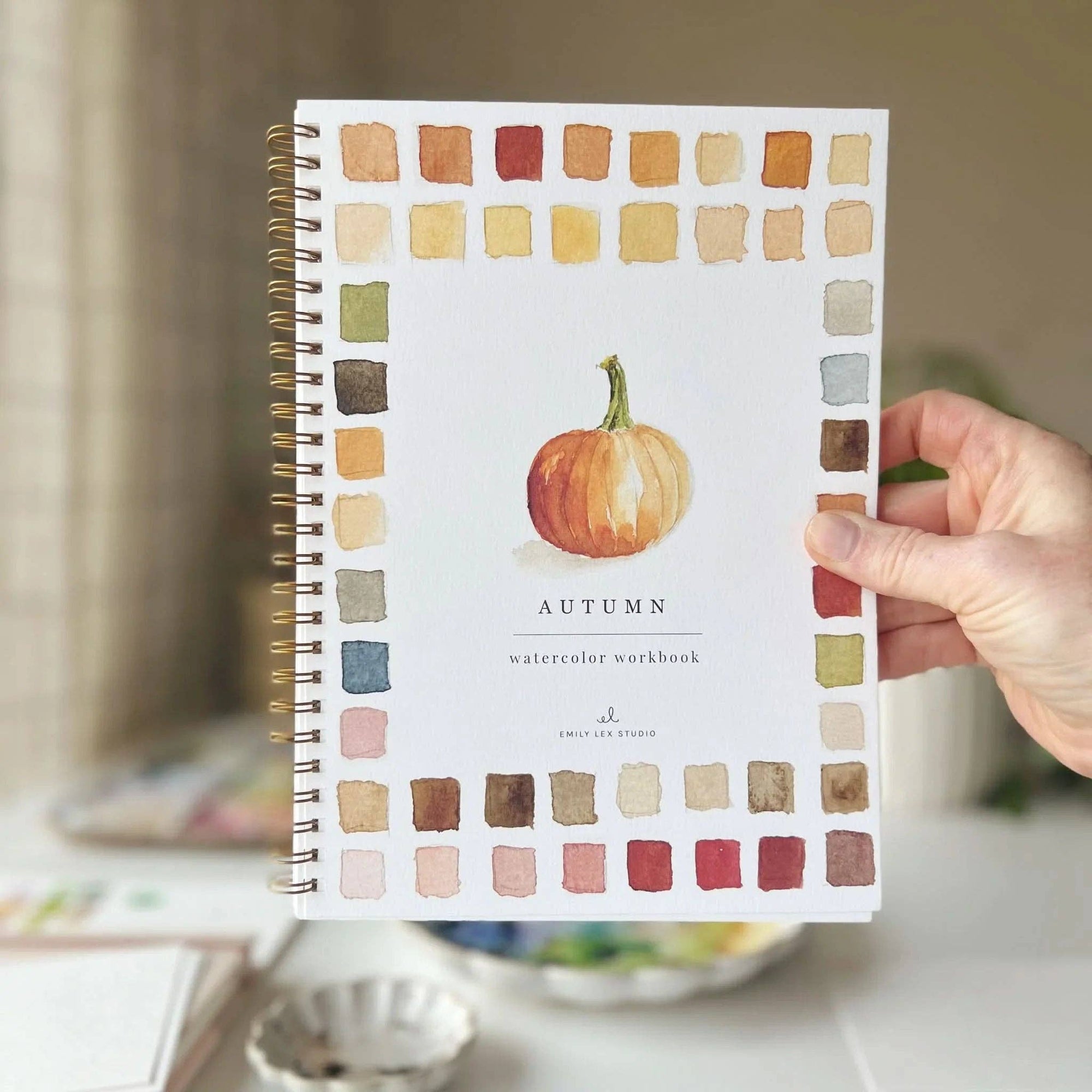 Autumn watercolor workbook cover with pumpkin illustration and watercolor color swatches