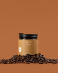 Amber Spiced Latte beeswax jar candle with black lid and scattered coffee beans