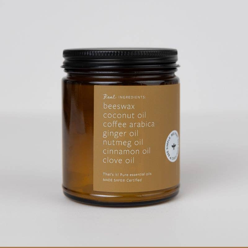 Brown glass beeswax jar candle labeled with essential oil ingredients and black lid