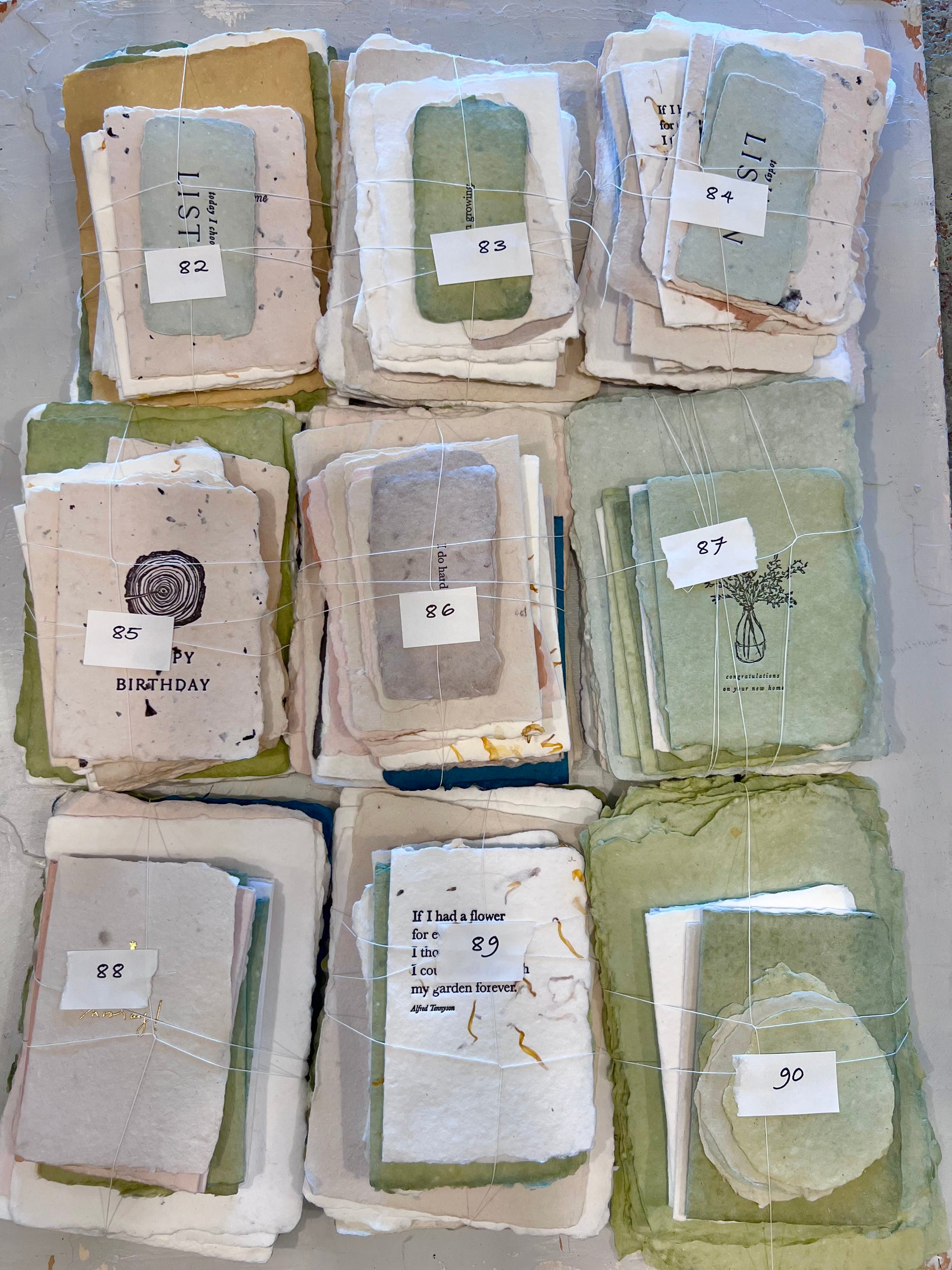 Assorted paper stationery odds bundle, numbered 82–90, wrapped sets in plastic sleeves