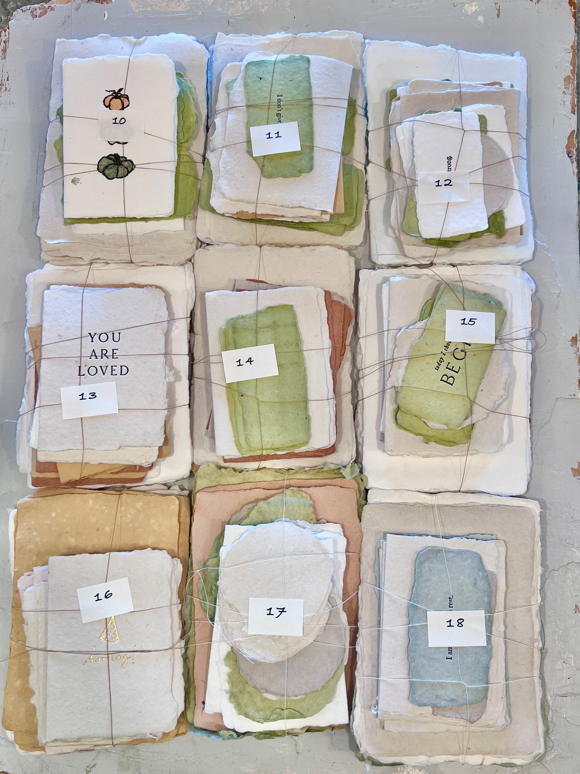 Mixed pastel odds paper bundles, labeled 10–18, tied in individual wrapped sets