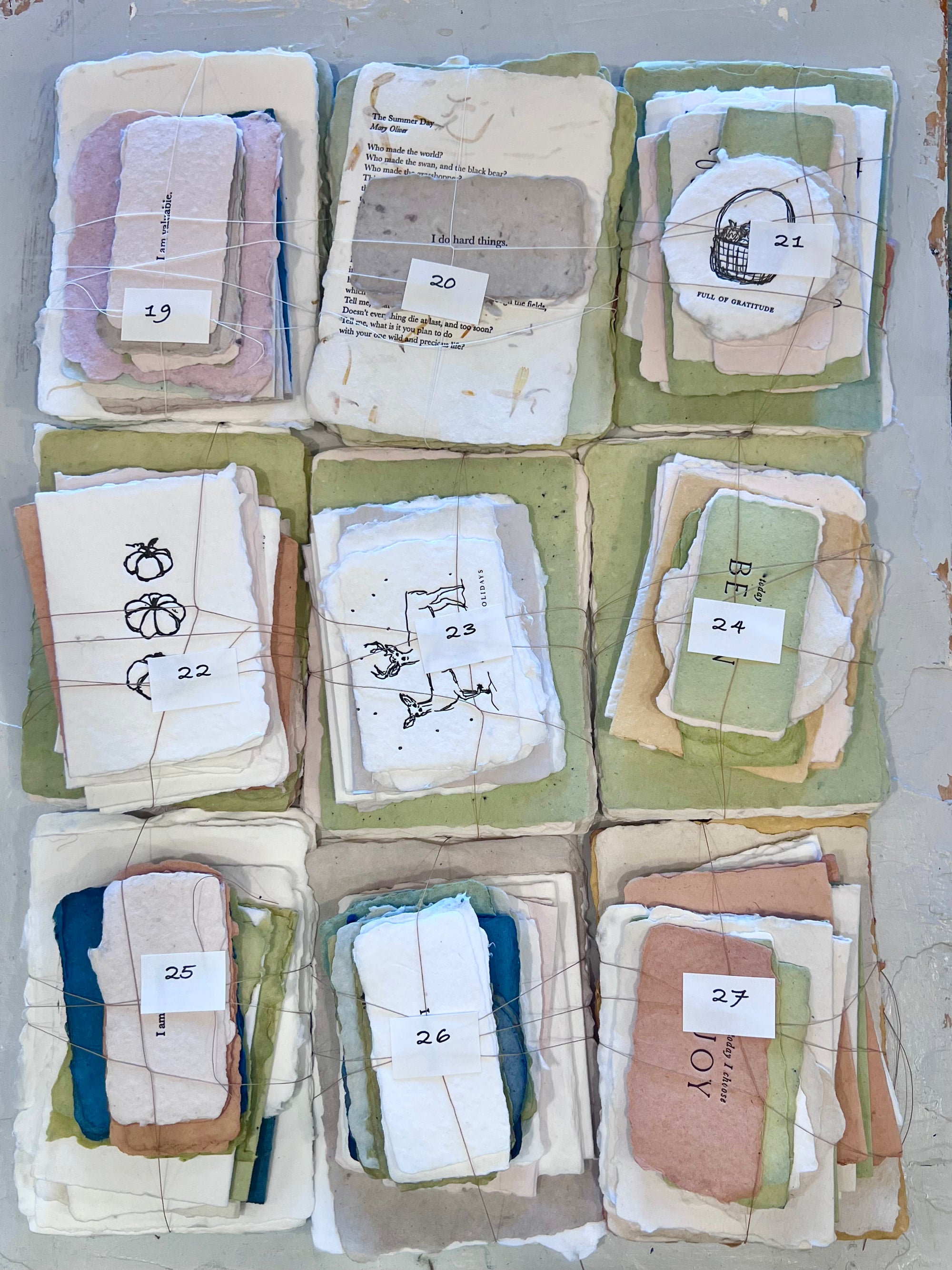 Assorted fabric bundle of mixed-colored cloth squares with numbered tags 019–027