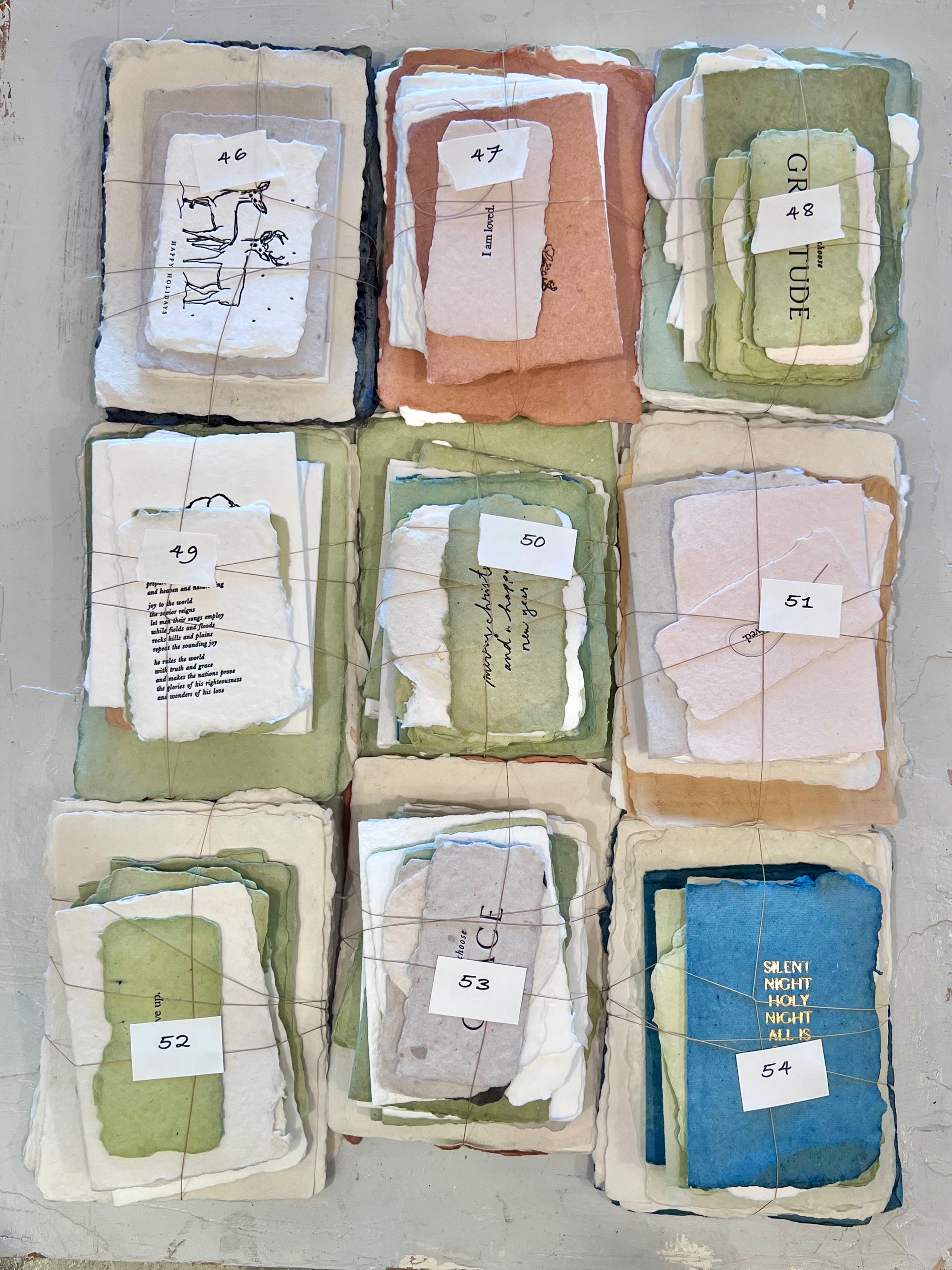 Assorted fabric bundle pack, multiple numbered bundles in plastic sleeves (046–054)
