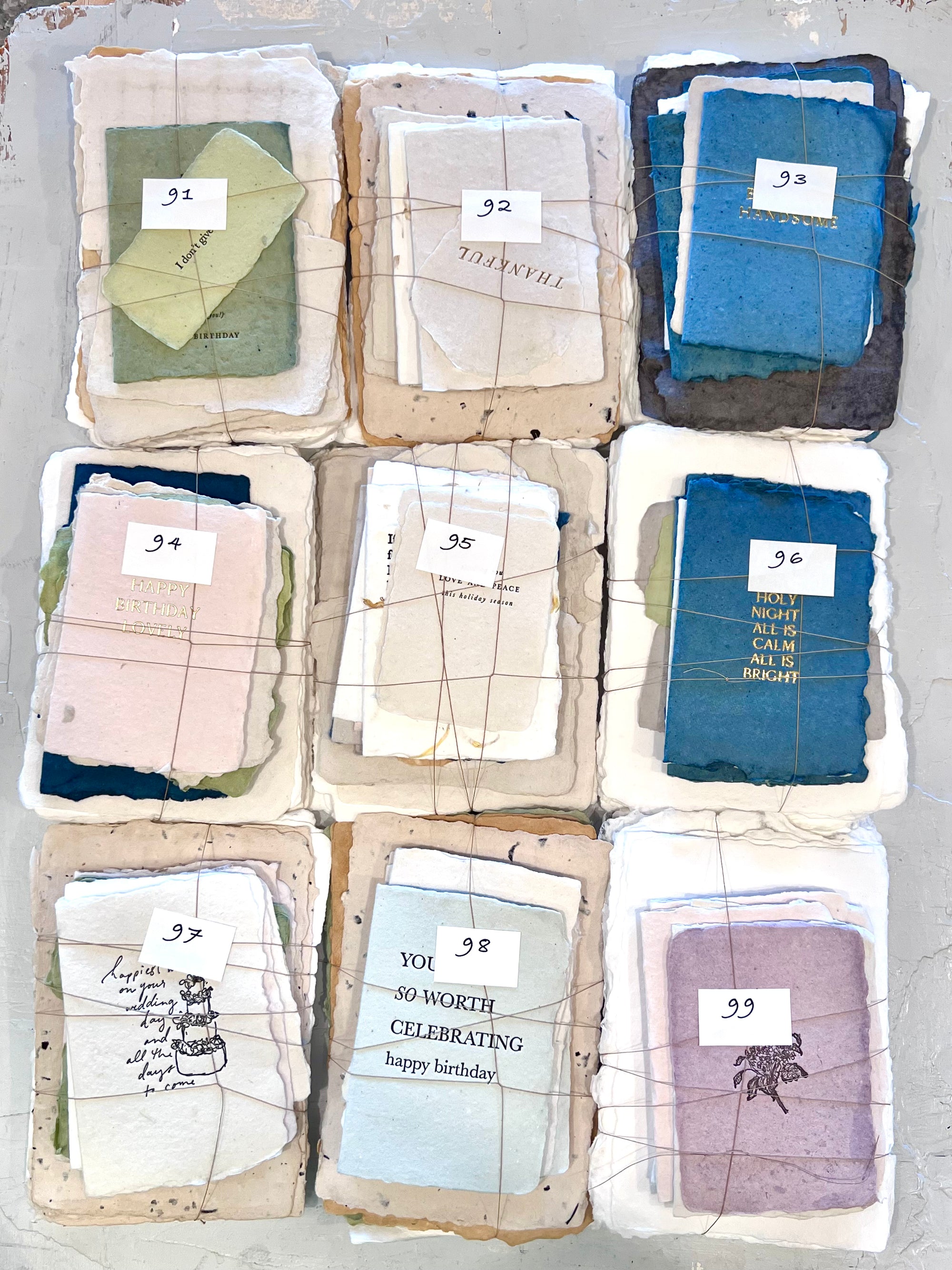 Assorted fabric square bundle set, numbered 91-99, multi-color folded squares