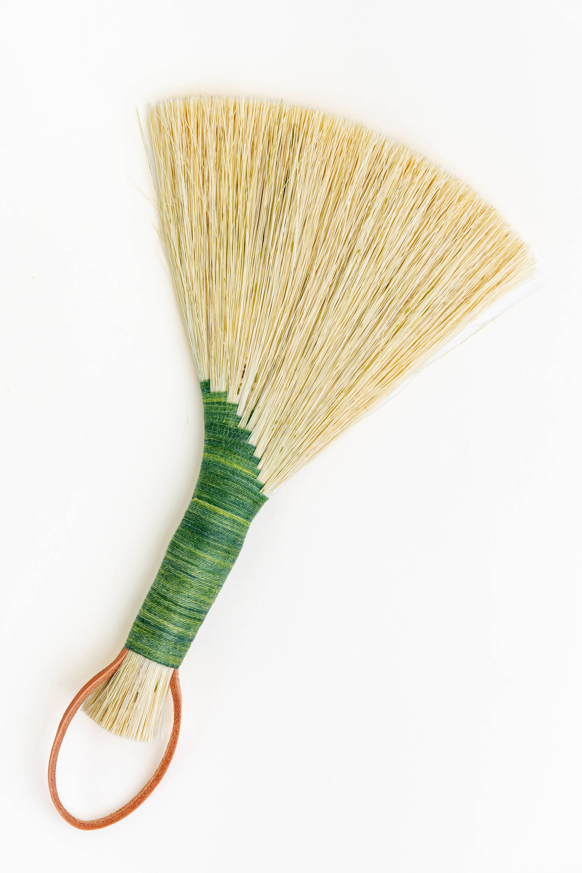 Green tampico wing brush with leather loop handle and striped wrap