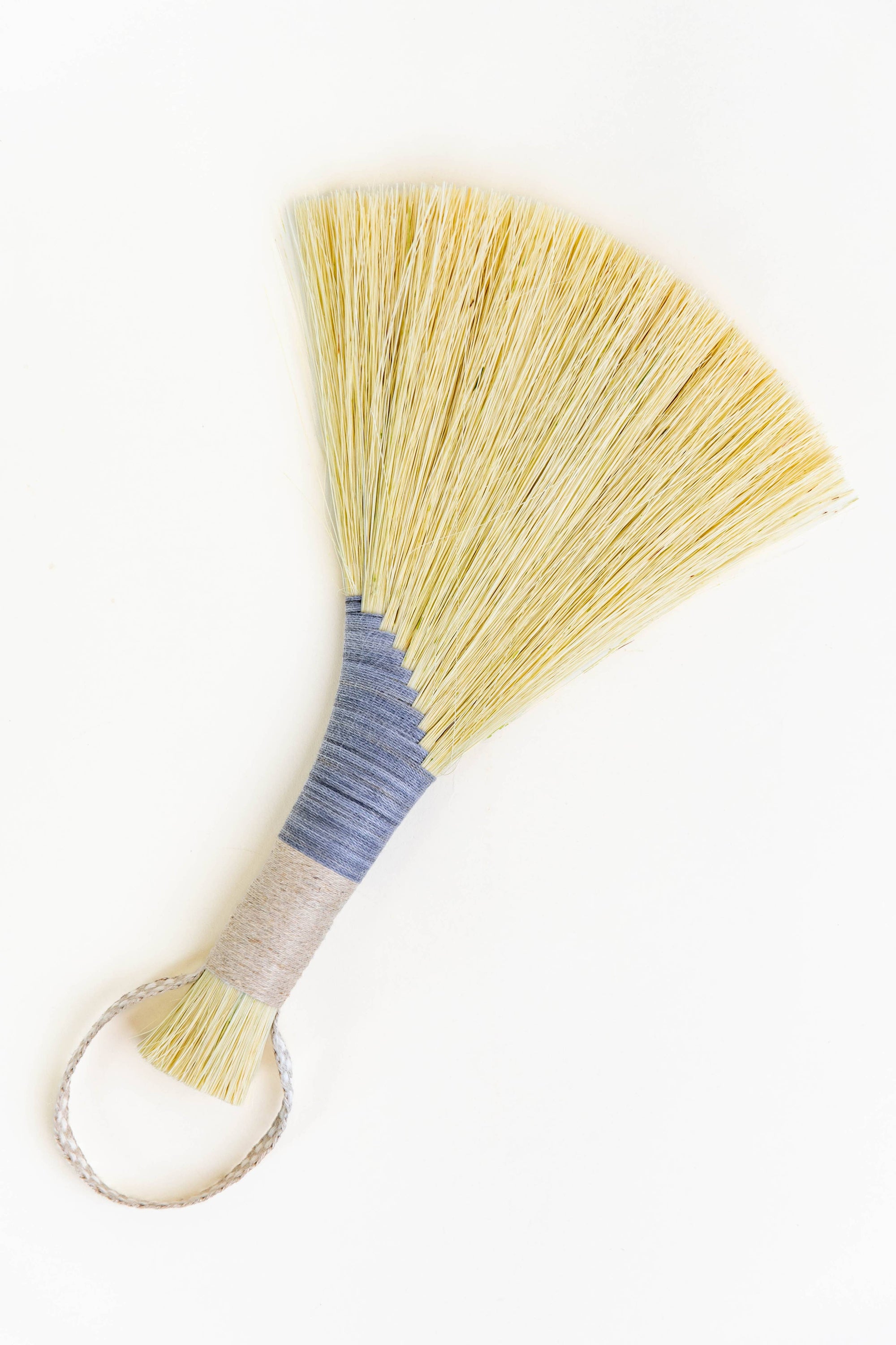 Tampico wing brush with yellow bristles, light blue wrap, and white braided cord loop