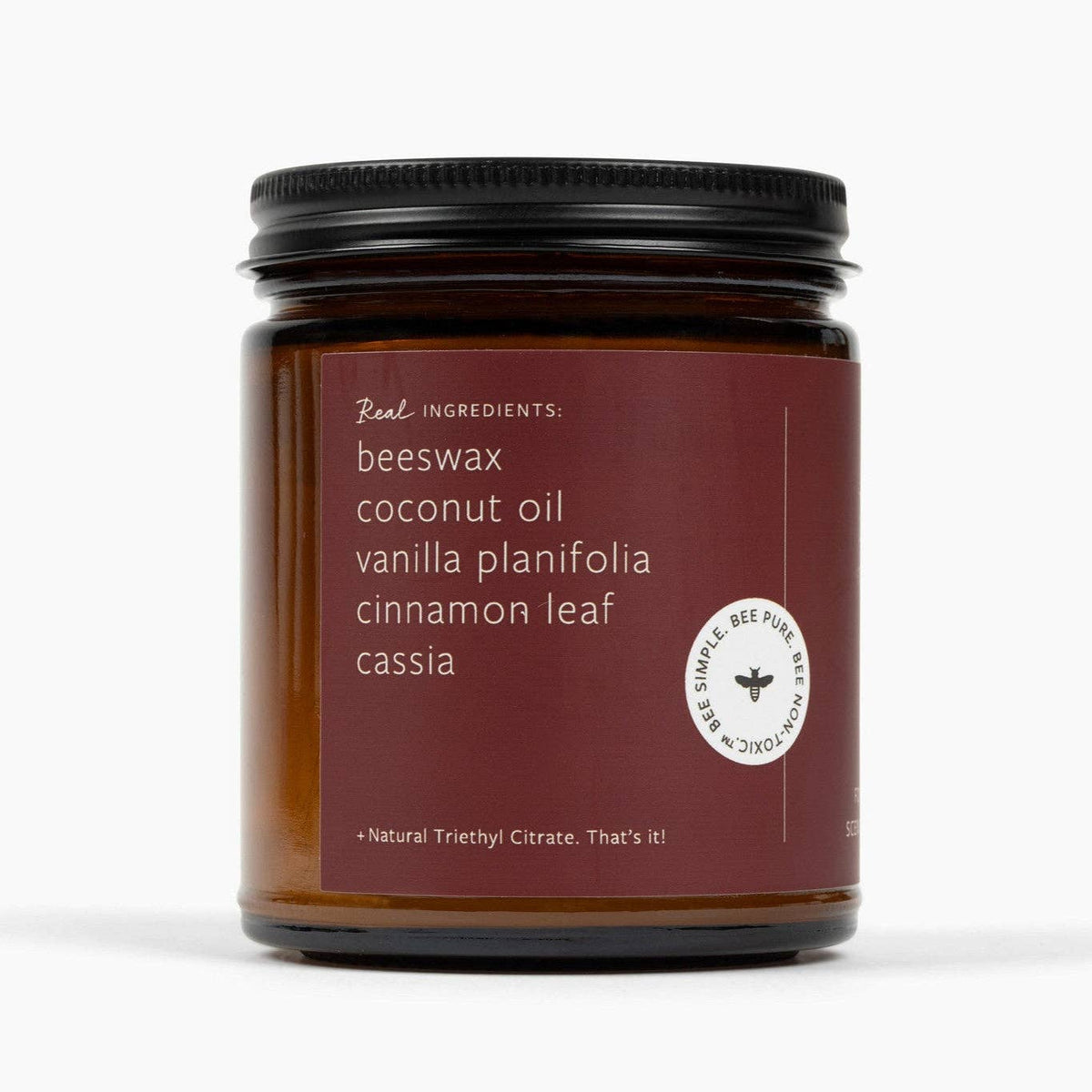 Brown beeswax candle jar with ingredients label and seal badge