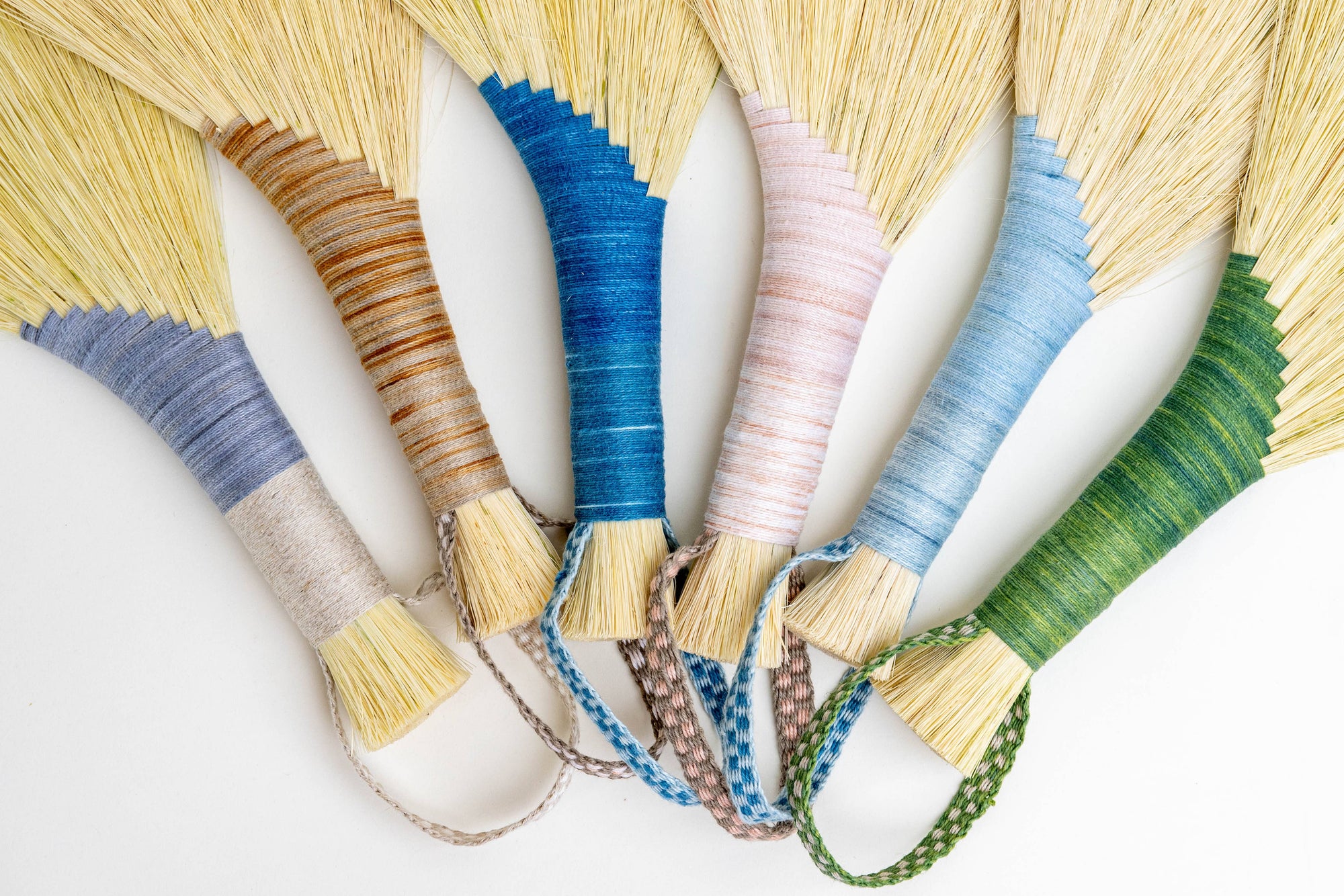 Tampico wing brush set close-up of yellow bristle fans with braided cords and straps