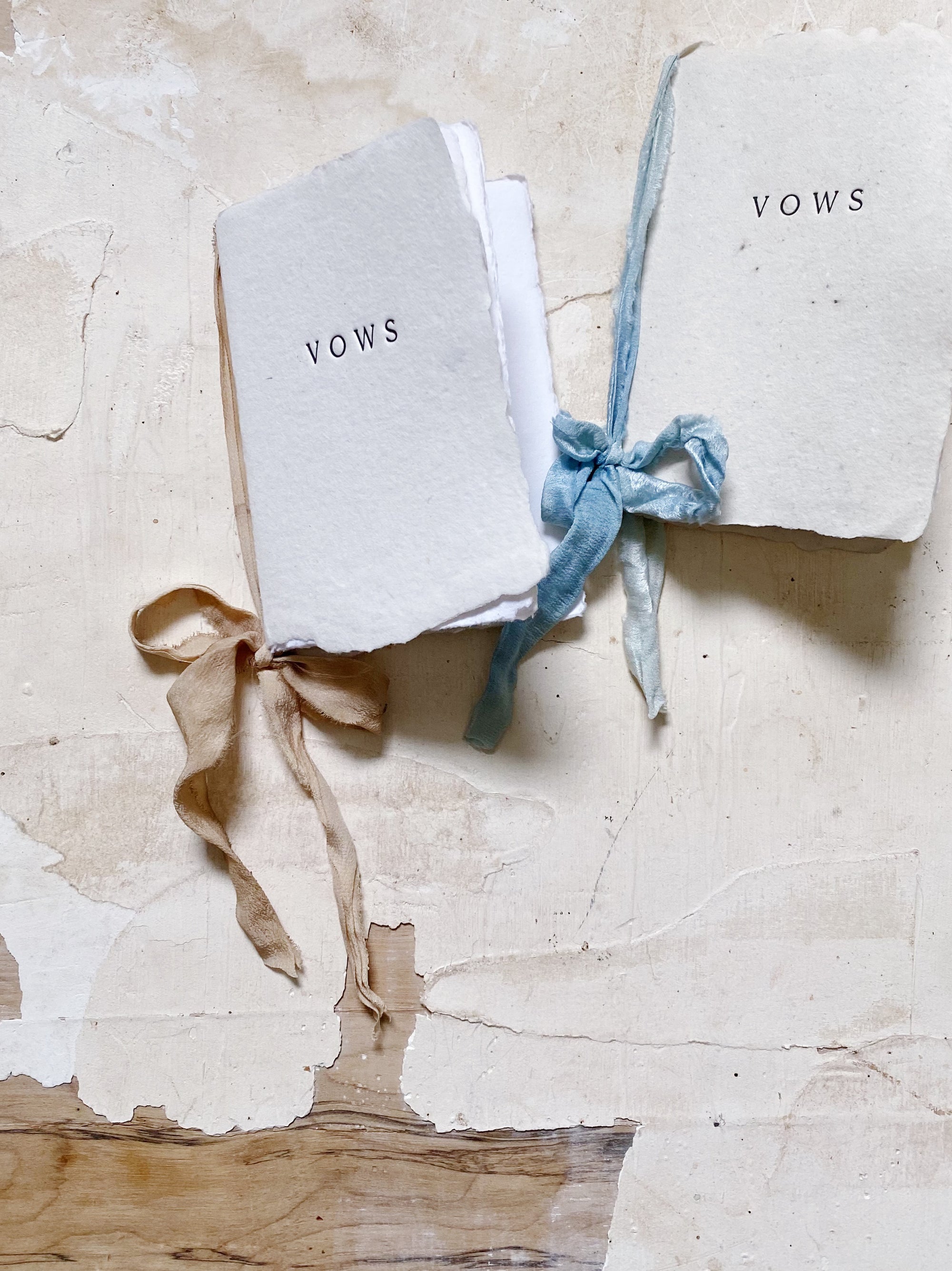Vow book with white cover and blue ribbon tie bow